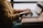 A small business owner happily working on a laptop in a cozy office.