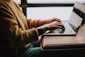 person sitting front of laptop