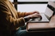 person sitting front of laptop