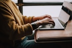person sitting front of laptop