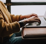 person sitting front of laptop