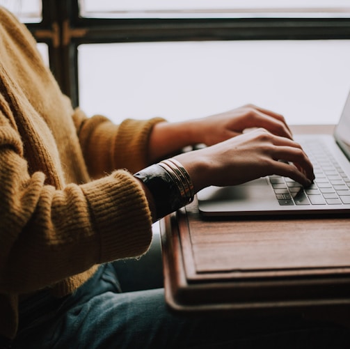 person sitting front of laptop