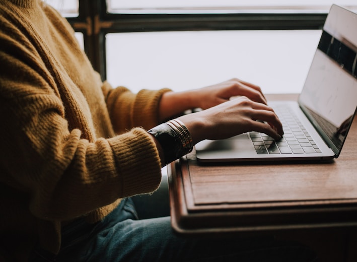 person sitting front of laptop