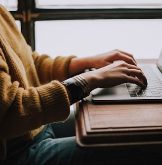 person sitting front of laptop