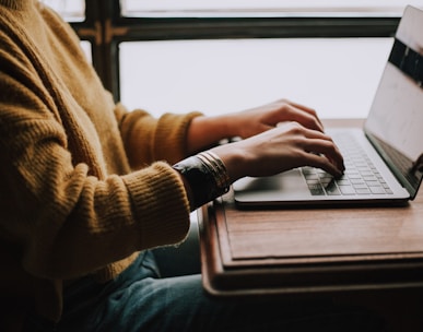 person sitting front of laptop