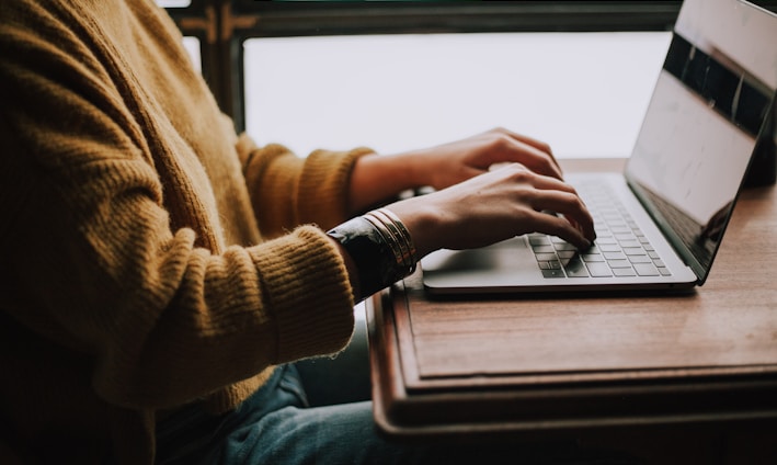 person sitting front of laptop