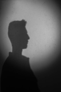 Portrait placeholder silhouette for the bio section, ready for a personal photo.