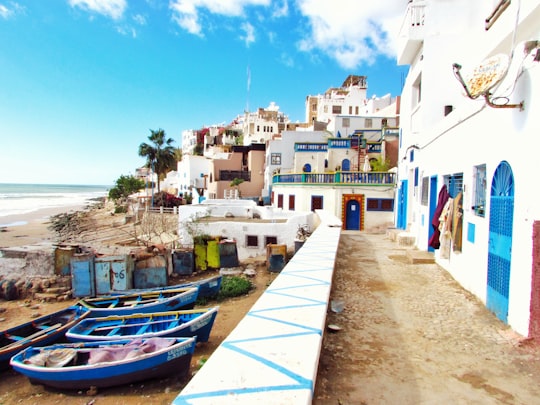 boatd docked near houses and body of water in Taghazout Morocco