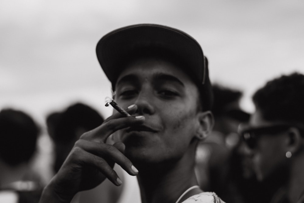 grayscale photography of man smoking