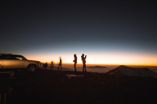 silhouette of group of people beside SUV in Mauna Kea United States