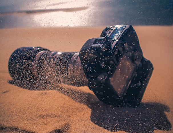 Canon camera on sandy beach