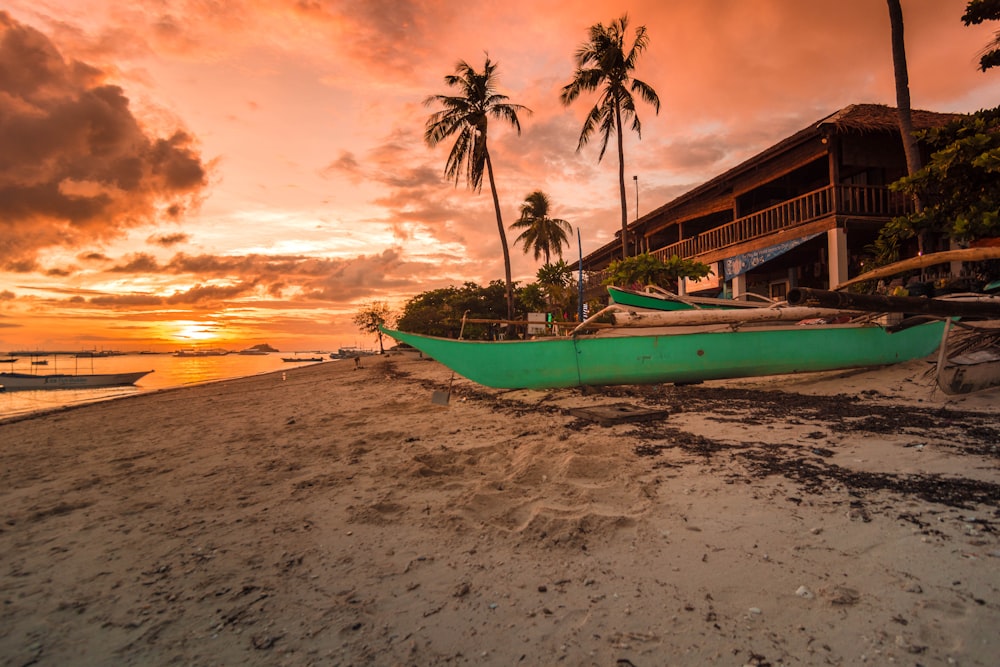 boat on seashore during sunset