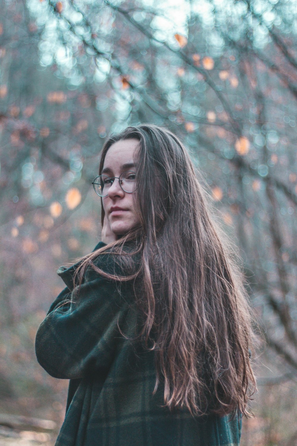 woman standing in woods during daytime