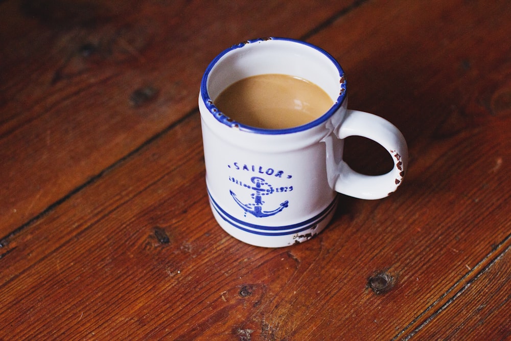 ceramic mug filled with brown liquid