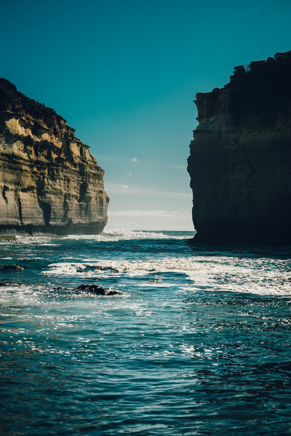 rock formations on body of water during daytime