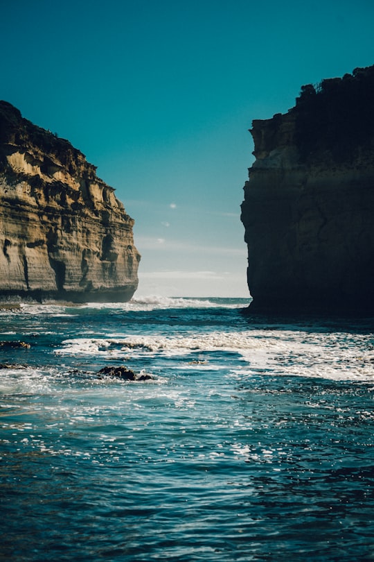 rock formations on body of water during daytime in Loch Ard Gorge Australia
