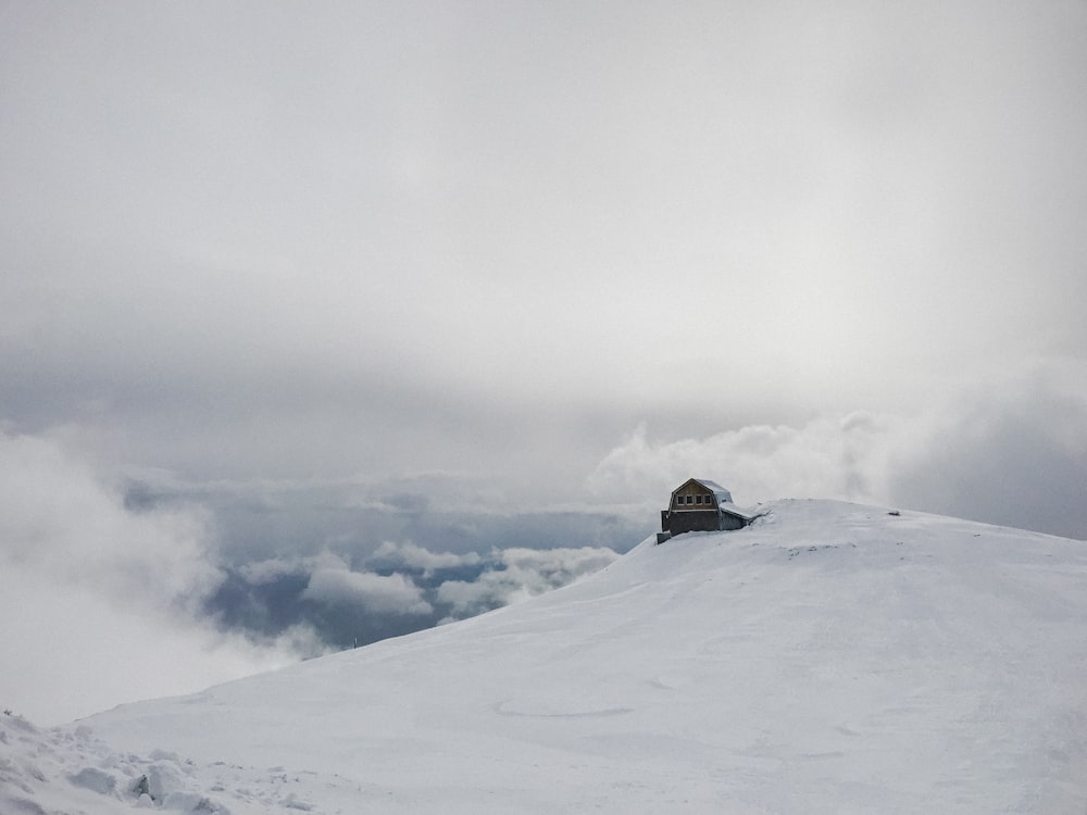 snow covered house under white clouds