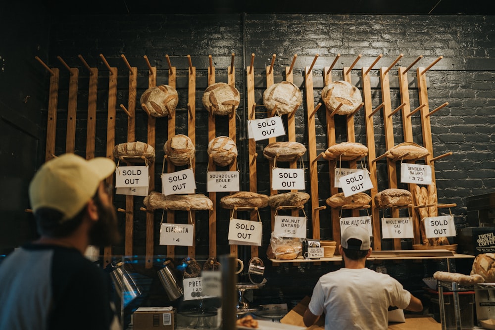 man standing in front of wooden rack