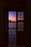 gray dome building near body of water at sunset