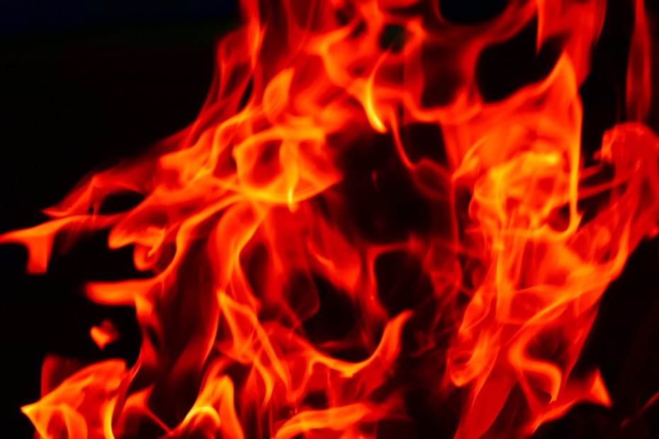 Vibrant red and orange flames with intricate patterns against a dark background, creating a sense of movement and intensity.