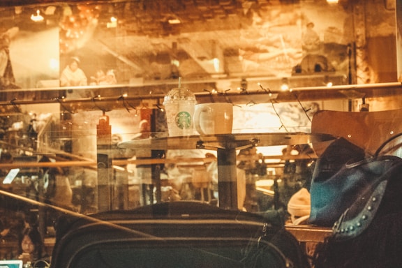 A cozy café setting with warm lighting and coffee cups.