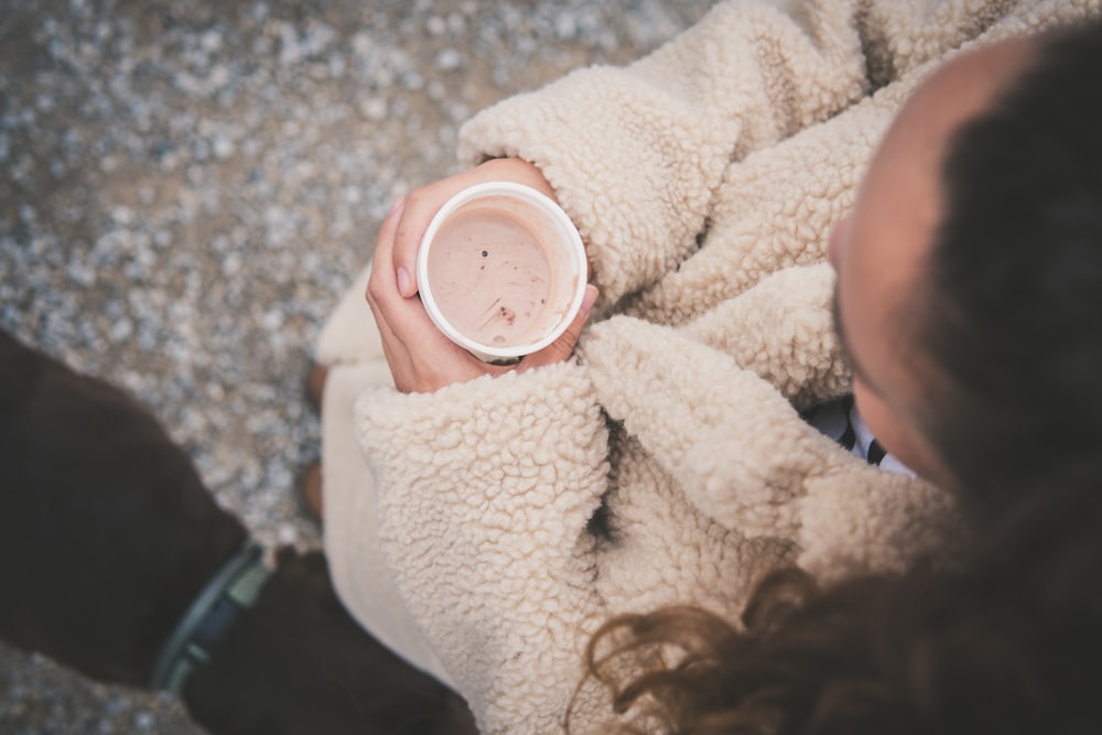 woman holding disposable cup