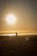 A person jogging on a scenic trail at sunrise, radiating joy and vitality.
