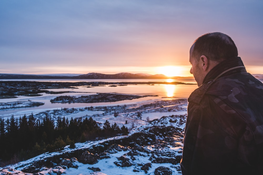 man standing on top of a mountain