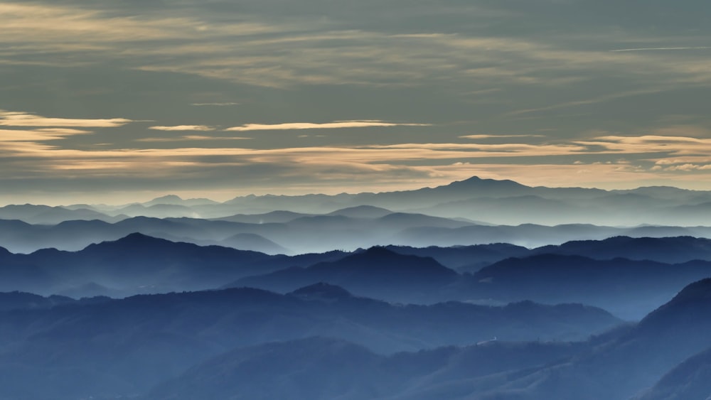 mountains under gray clouds during daytime