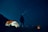 A happy customer using the Smart Team Holdings camping lamp during a night camping trip.