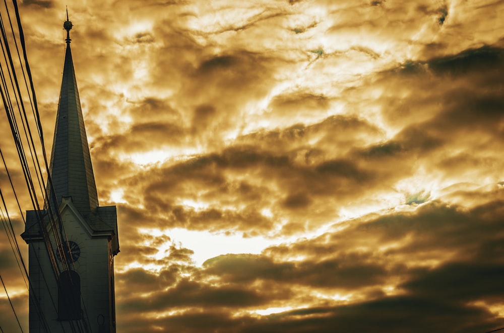 church under orange cloudy sky