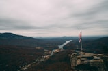 A scenic view of Idaho’s mountains with a waving American flag in the foreground.