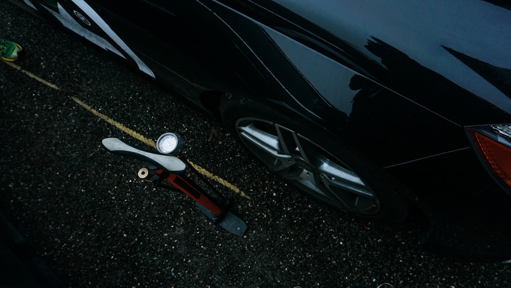 a black car parked next to a yellow line