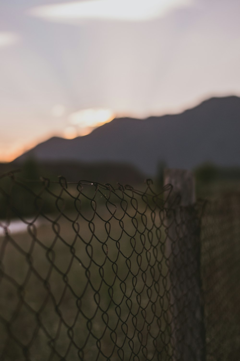 selective focus photo of black chain link fence