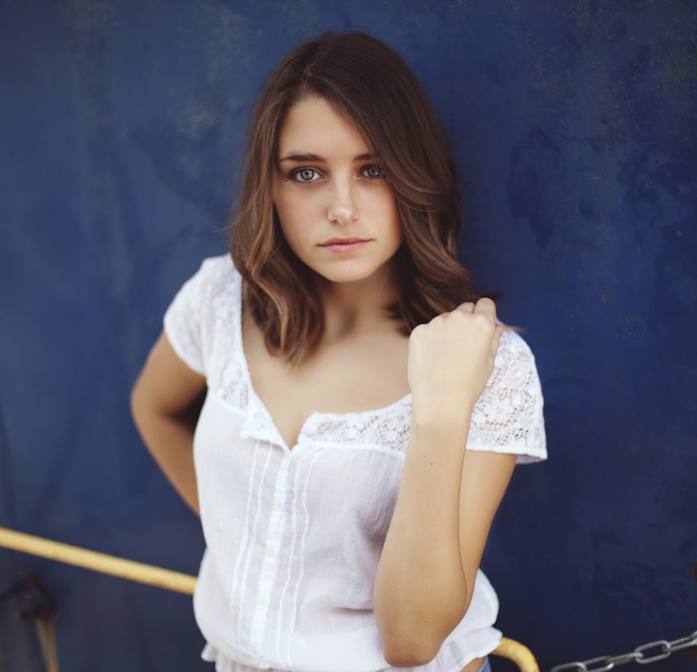 woman standing near blue wall