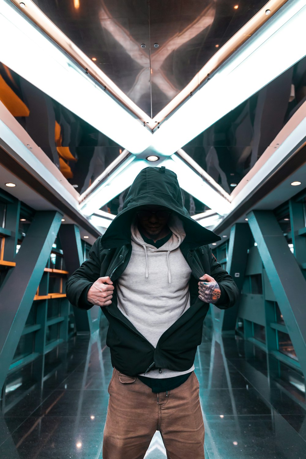 man holding his green hoodie