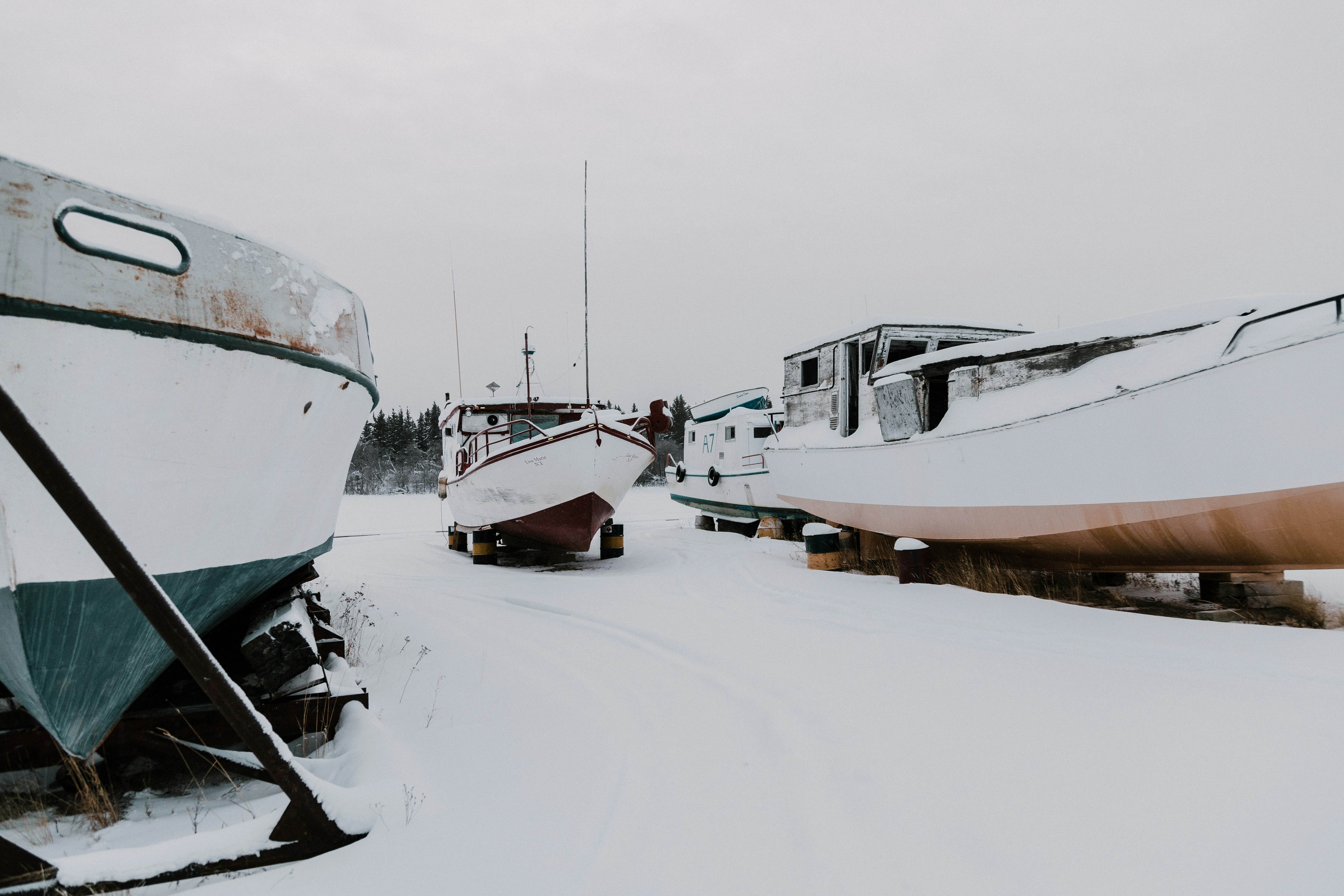 three boats on snow ground