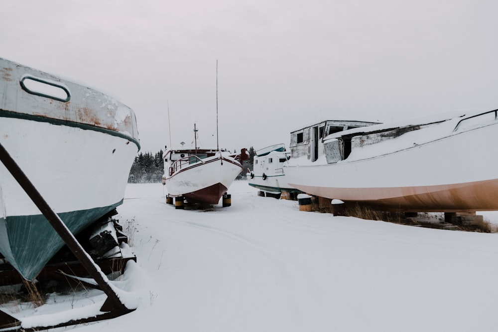 three boats on snow ground