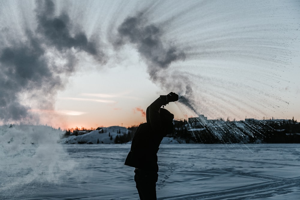 silhouette of person raising hands