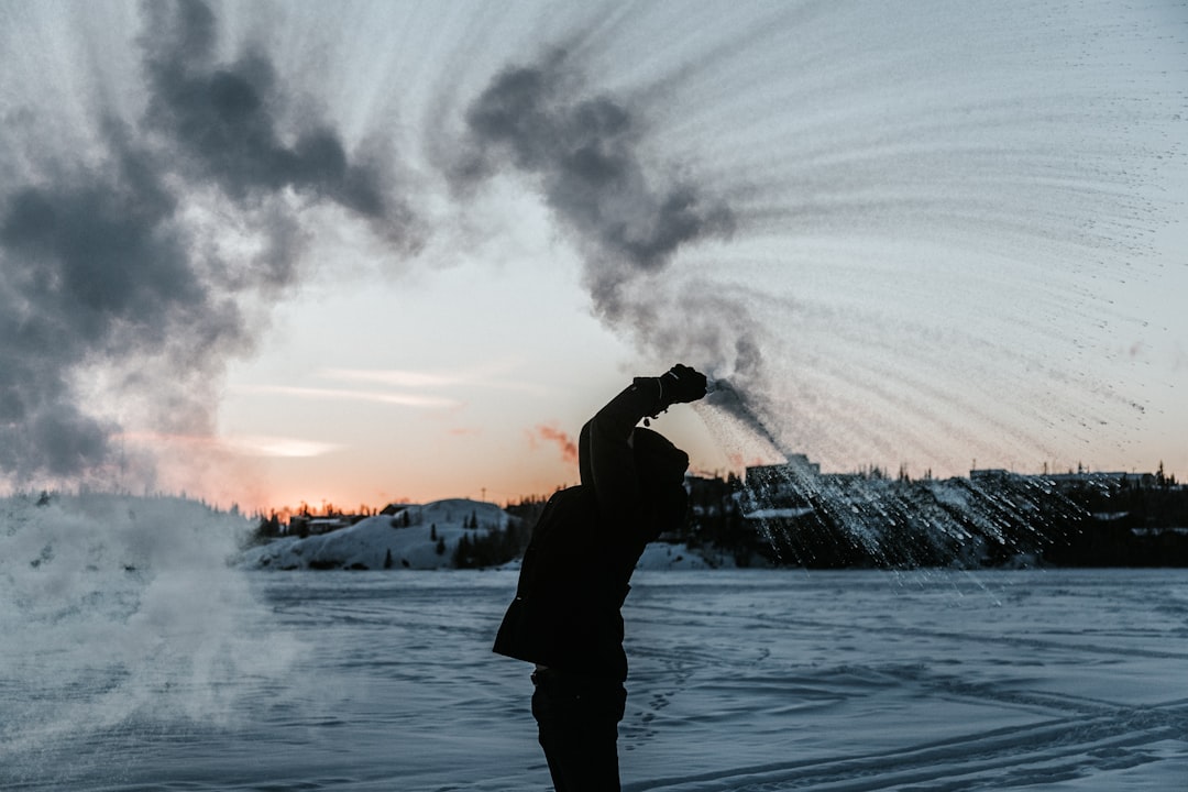 silhouette of person raising hands