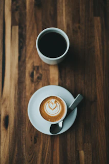 Close-up of a traditional Turkish coffee cup with foam art on a rustic wooden table