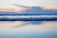 A serene seascape at dusk, colors fading softly into the horizon, symbolizing calm after trauma.