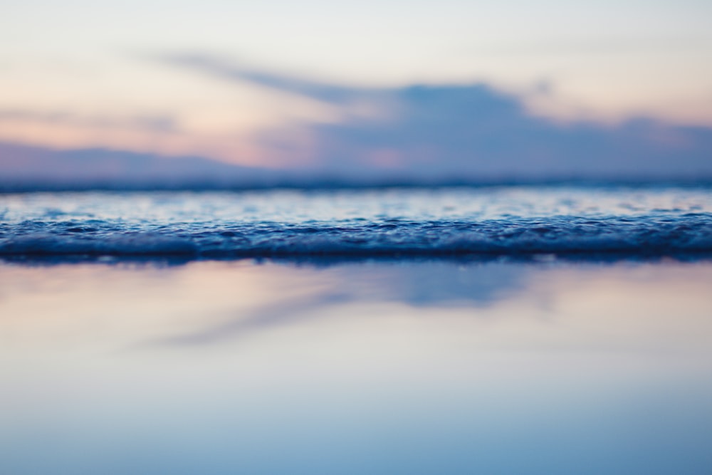 a body of water with a sky in the background