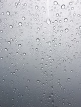 A smooth slideshow frame showing water droplets glistening on a beige surface.