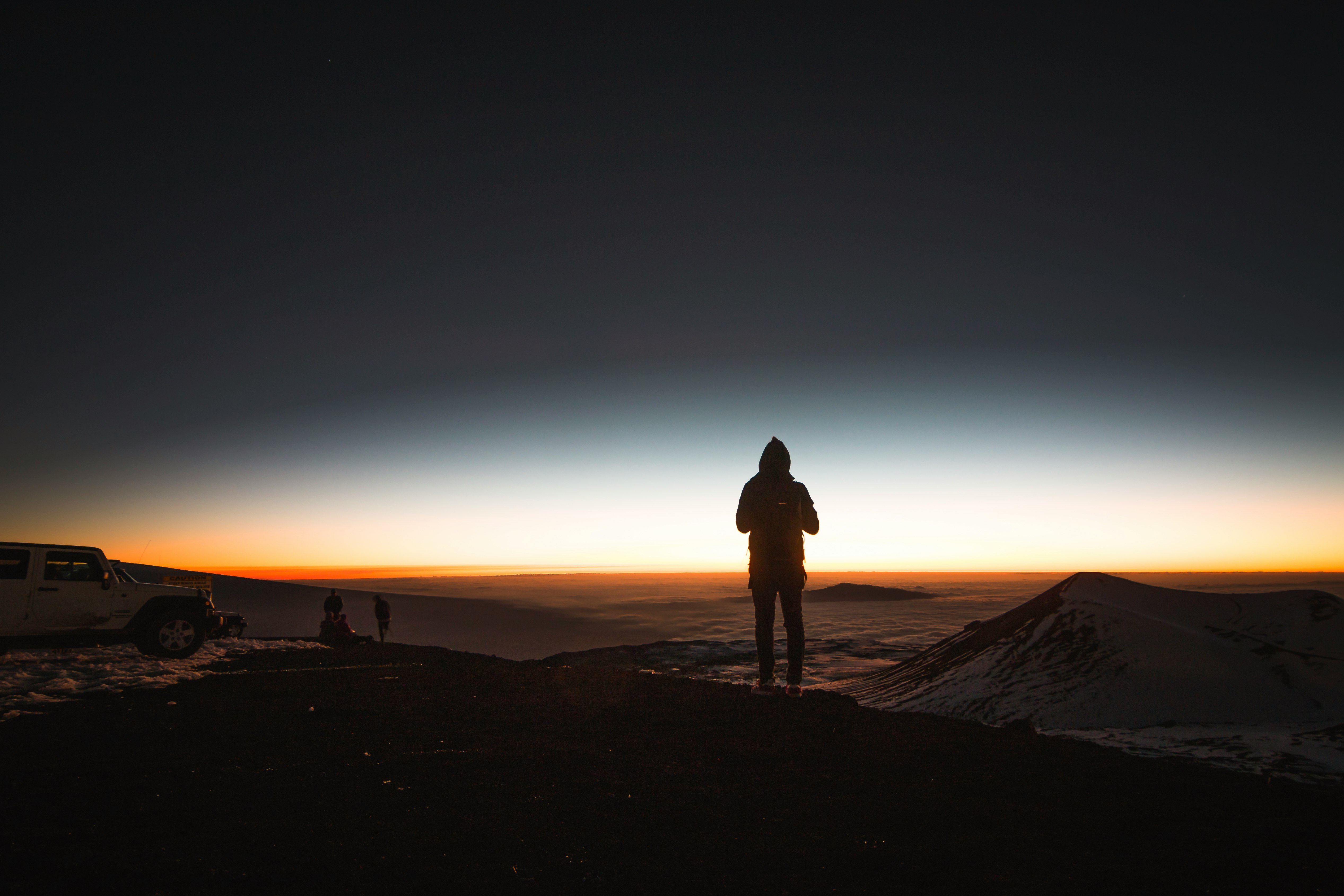 man standing on top of mountain