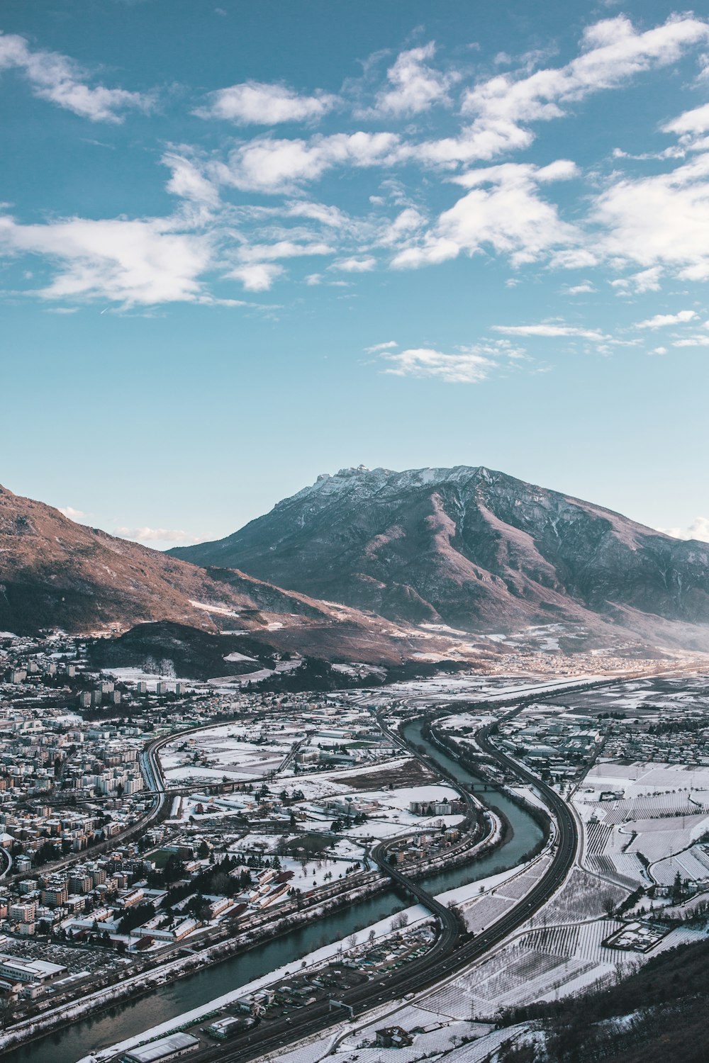 aerial view photography of body of water near mountain at daytime