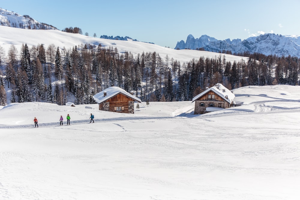 people standing on snow covered mountain