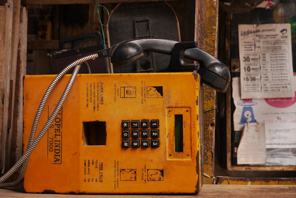 public telephone near window with papers