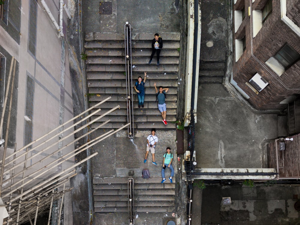 aerial photography of five person's lying on sair