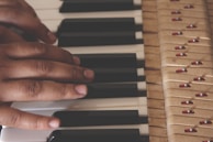 Close-up of hands playing piano keys during a lesson.